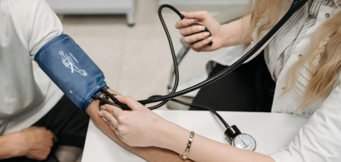 Doctor checking blood pressure